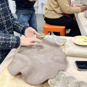 Students molding raw clay for their own charcuterie board during a workshop at slip studio in white plains NY